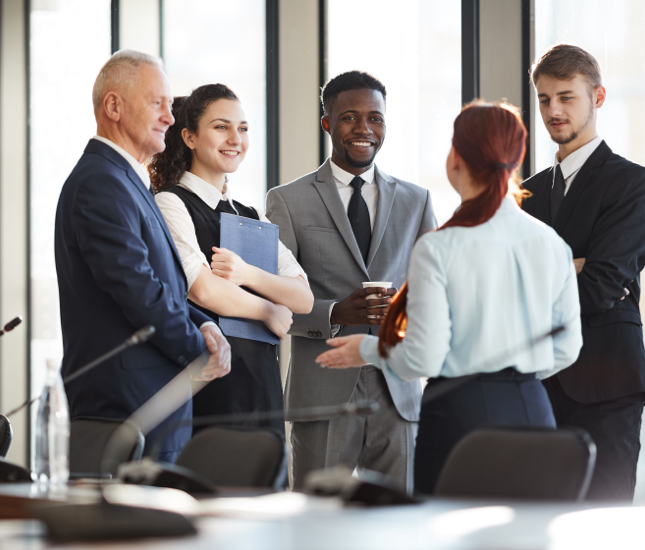 A group of business people standing together in a conference room.