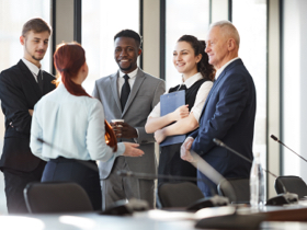 A group of business people standing together in a conference room.