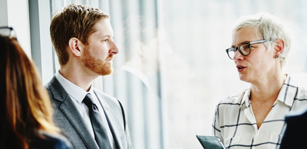 A woman speaking to a man.